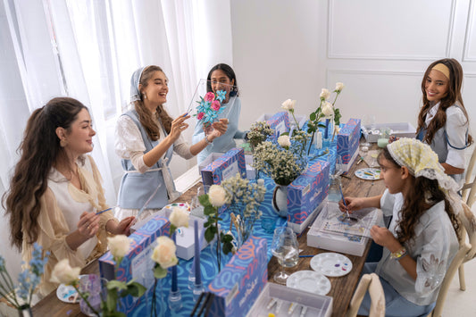 Adults painting georguess lucite crafts.